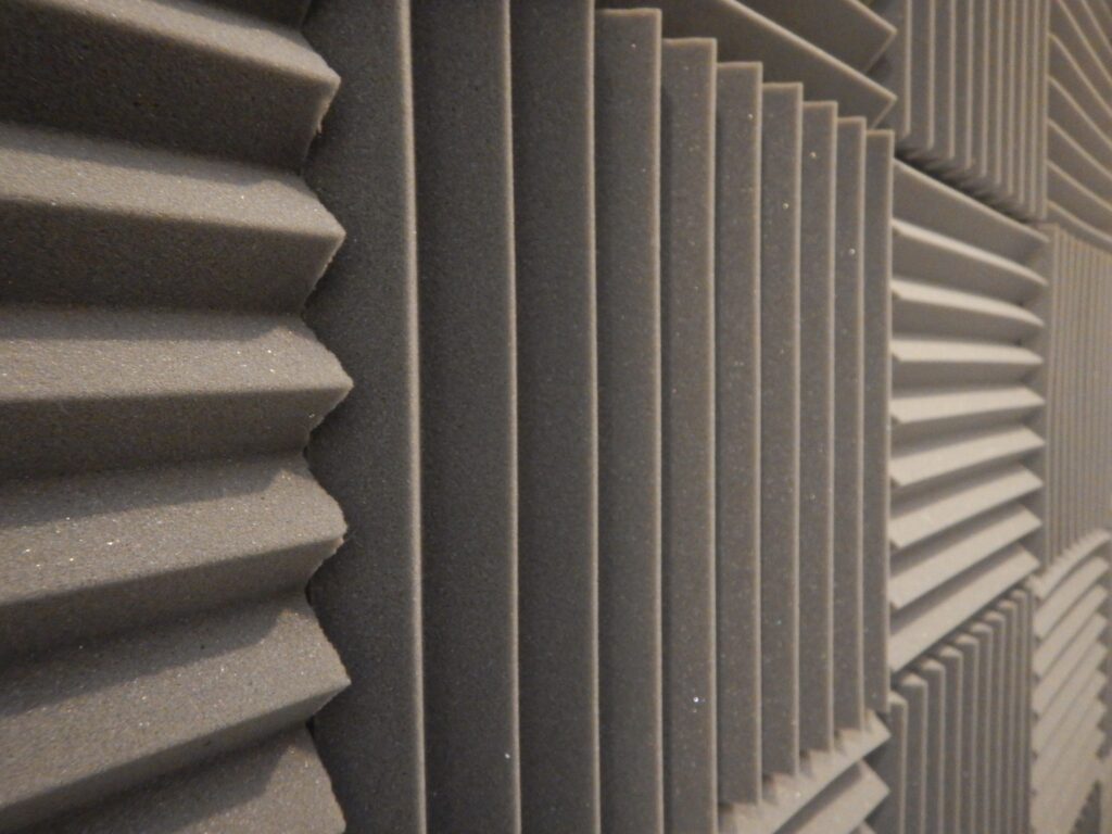 Gray geometric acoustic foam panels on soundproof recording studio wall