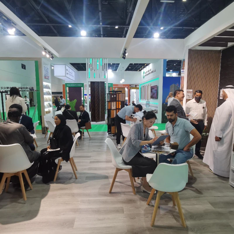 Business professionals networking at modern trade fair expo with tables, booths, and multicultural attendees