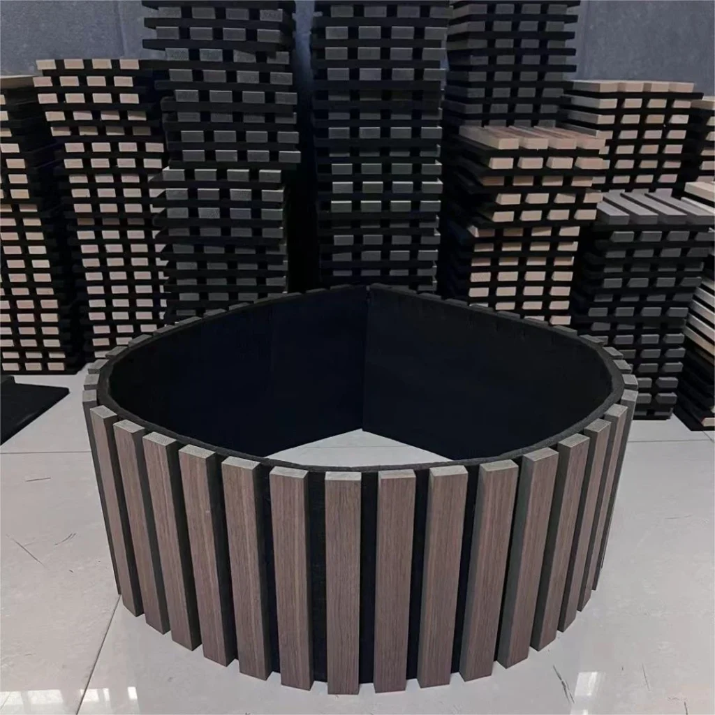 Large circular acoustic panel installation surrounded by stacked modular panels in a warehouse.