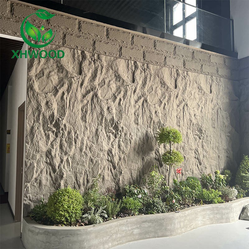 Indoor garden with sculptural stone-textured wall and curved concrete planter in modern interior.