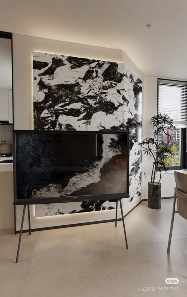 Modern living room with black and white marble feature wall and minimalist TV.