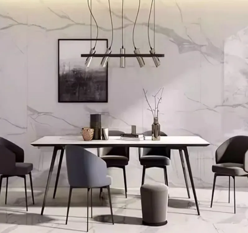 Modern minimalist dining room with marble wall, sleek table, gray chairs, and pendant lighting