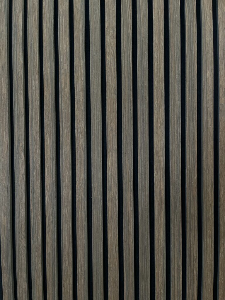 Modern vertical wood slat wall paneling with black gaps, minimalist interior design