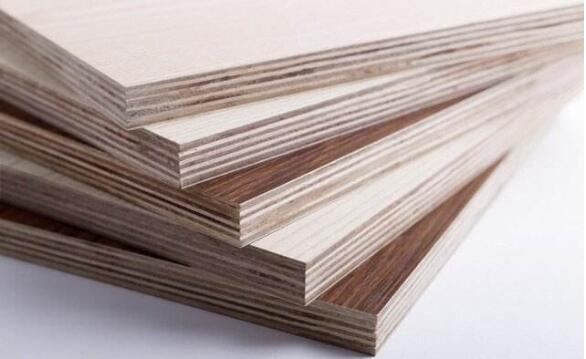 Stack of high-quality layered plywood sheets with visible cross-grain edges