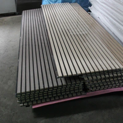 Neatly stacked metal bars on warehouse floor in industrial storage area