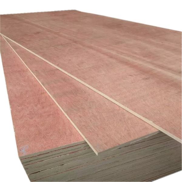 Stacked plywood sheets with smooth pink surfaces and visible layered edges.