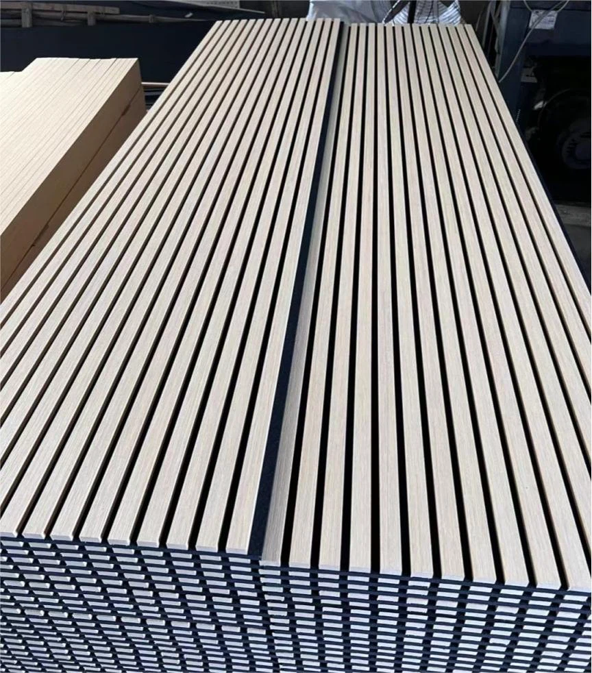 Stacked smooth wooden planks aligned in a workshop, showing craftsmanship and order