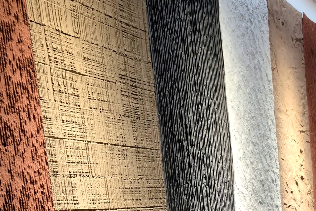 Vertical textured wall panels in earthy tones showcasing architectural surface finishes