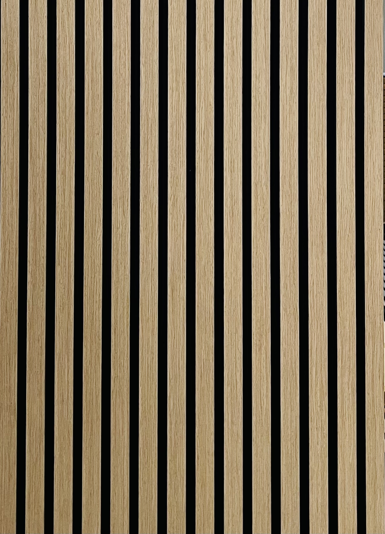 Modern wood slat wall with black gaps creating minimalist vertical pattern
