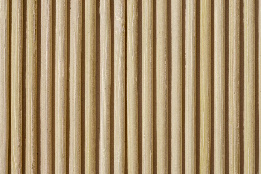 Close-up of vertical wooden slat wall with warm tones and natural grain